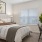 a bedroom with a bed and a chair