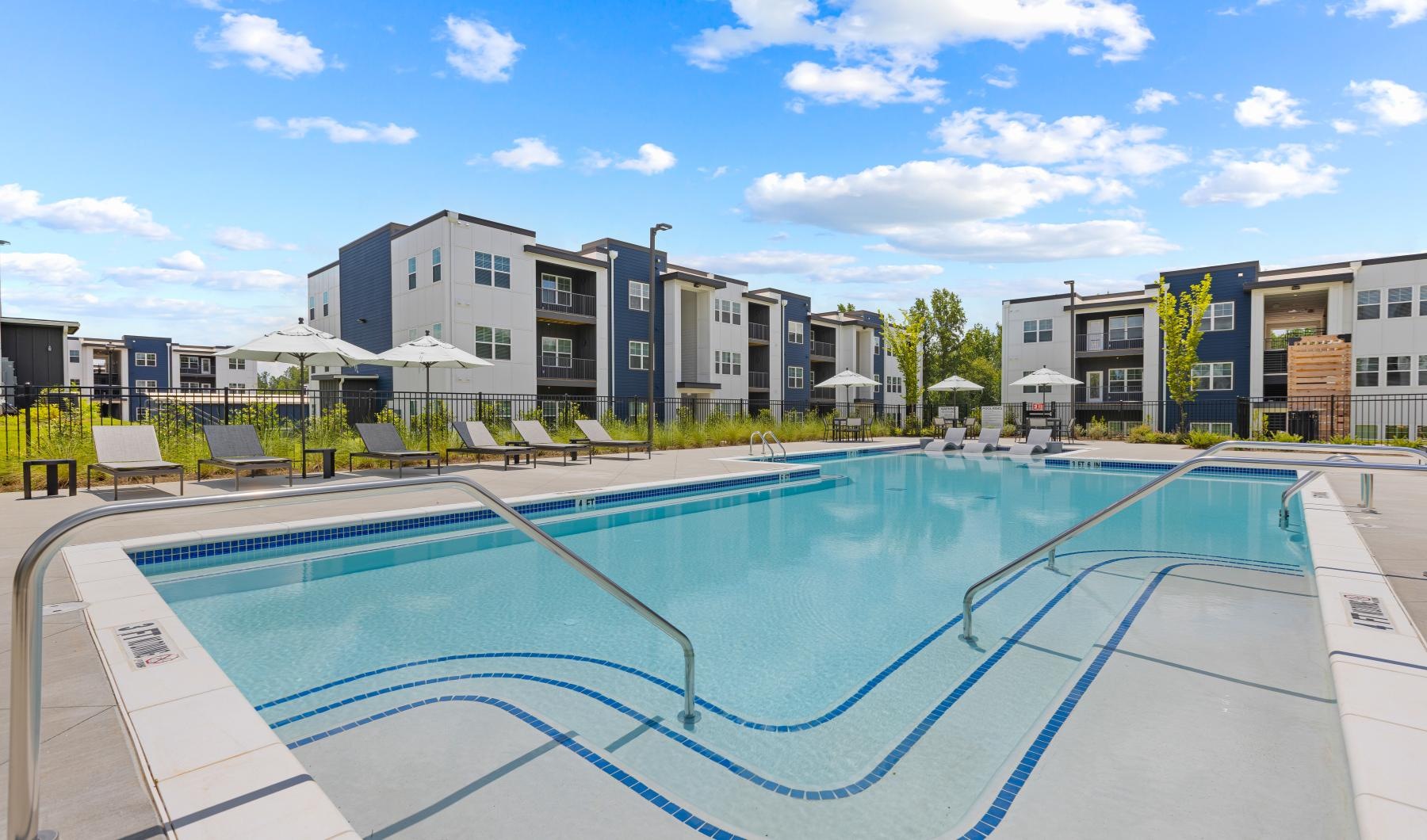 a swimming pool with buildings in the background