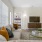 a living room with a large window, a couch and a tv