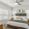 a bedroom with a bed and a fan