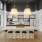 a clubhouse kitchen with a bar stools and a table