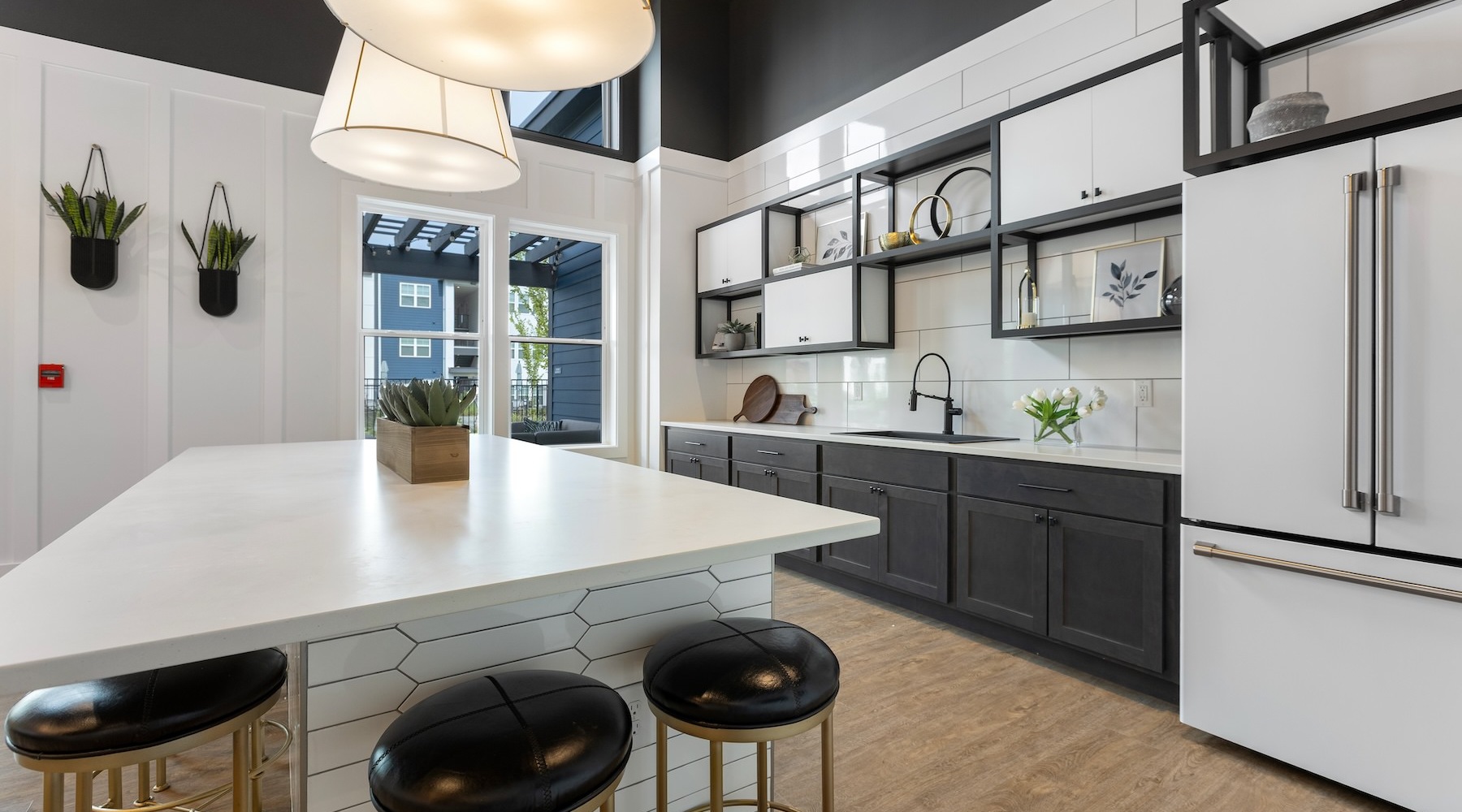 a clubhouse kitchen with a large island and stools