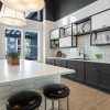 a clubhouse kitchen with a large island and stools
