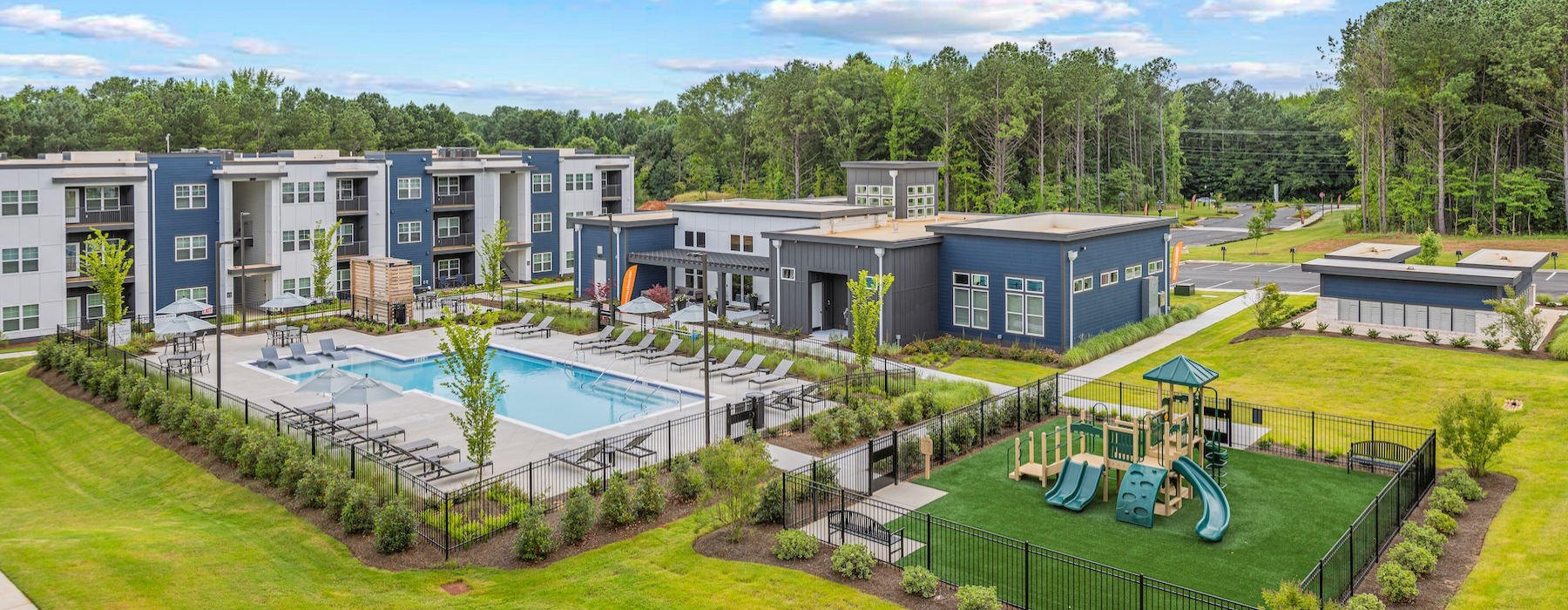 a group of buildings with a swimming pool in front of them