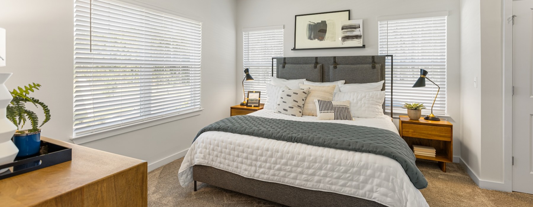 a bedroom with a bed and a fan