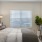 a bedroom with a bed and a chair