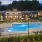 a swimming pool with a house in the background