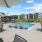 a pool with chairs and umbrellas