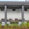 a building with a few chairs and a few plants in front of it