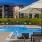 a pool with a lounge chair and umbrella by it